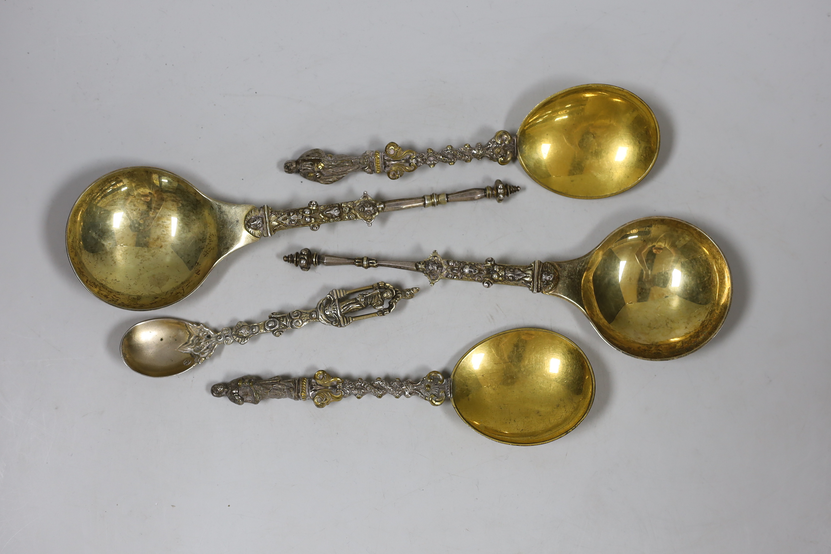 Two Victorian parcel gilt silver apostle spoons, London, 1879 and 1882, 20.2cm, 4.5oz and three other spoons.